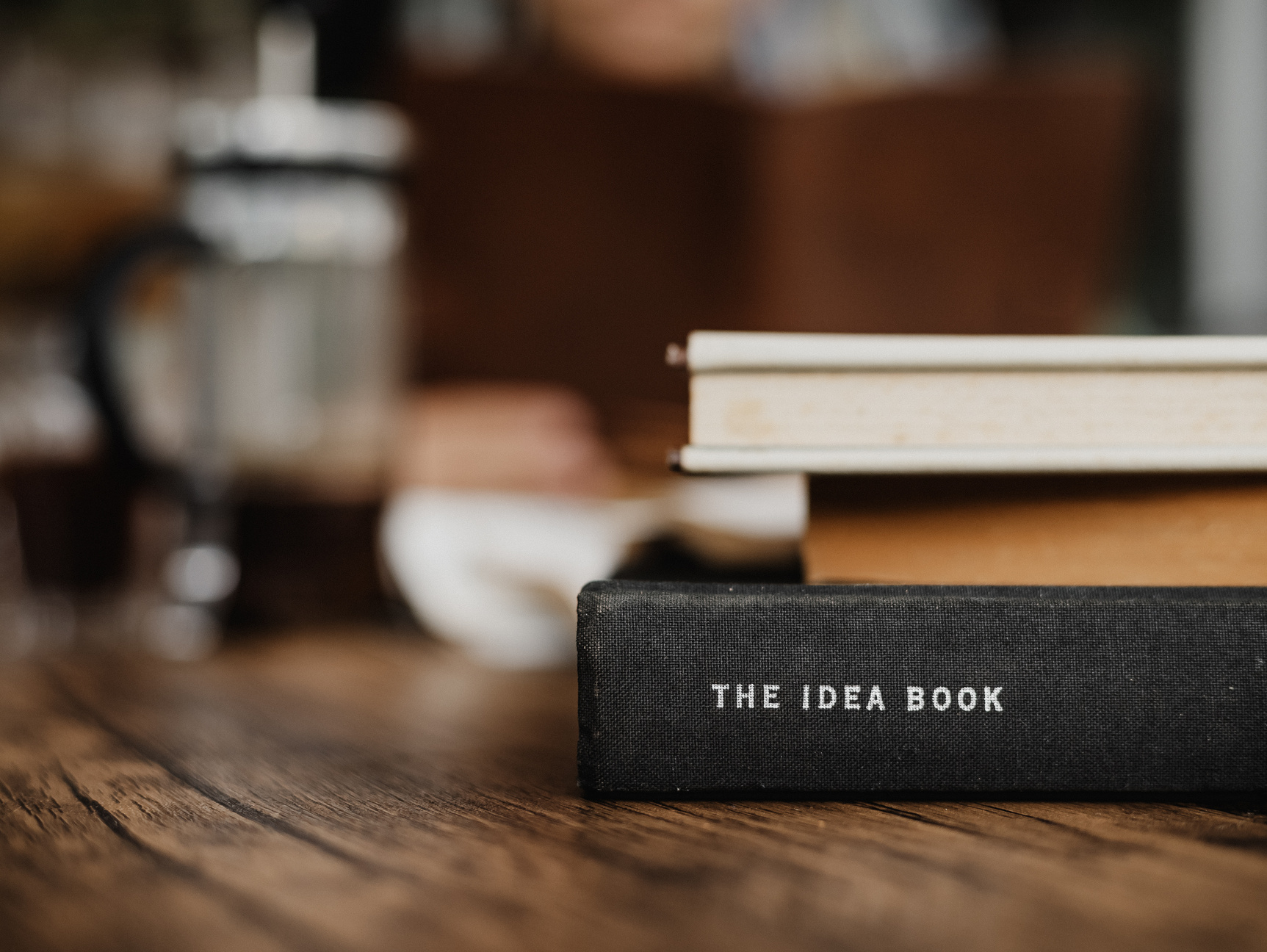 Pile of Books on Wooden Table